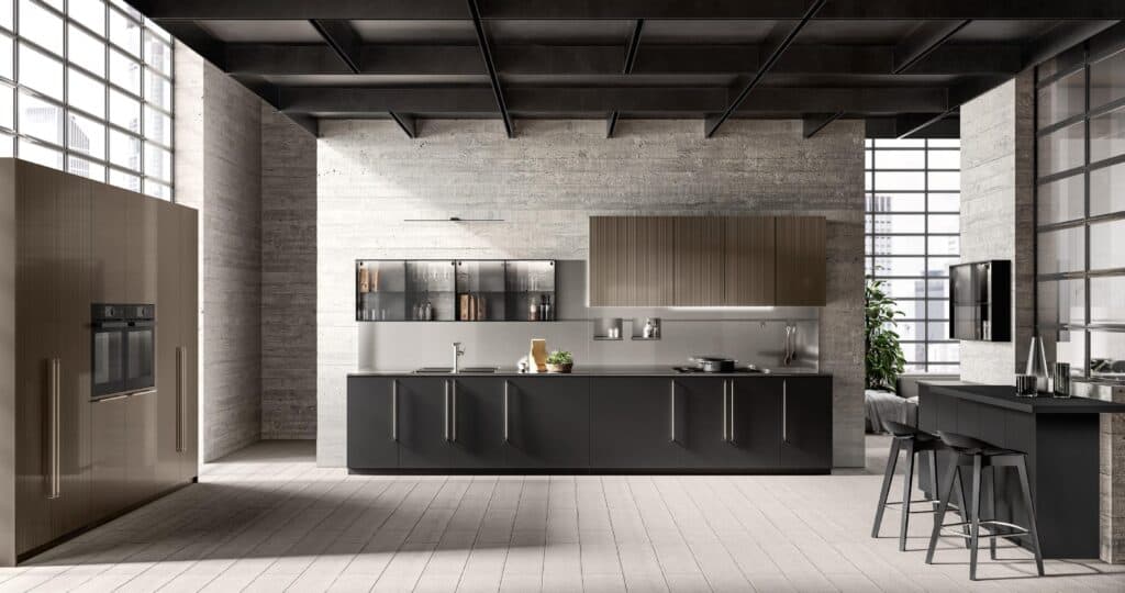 Modern kitchen with sleek, dark cabinetry, a central island with bar stools, stainless steel appliances, and large windows providing natural light.