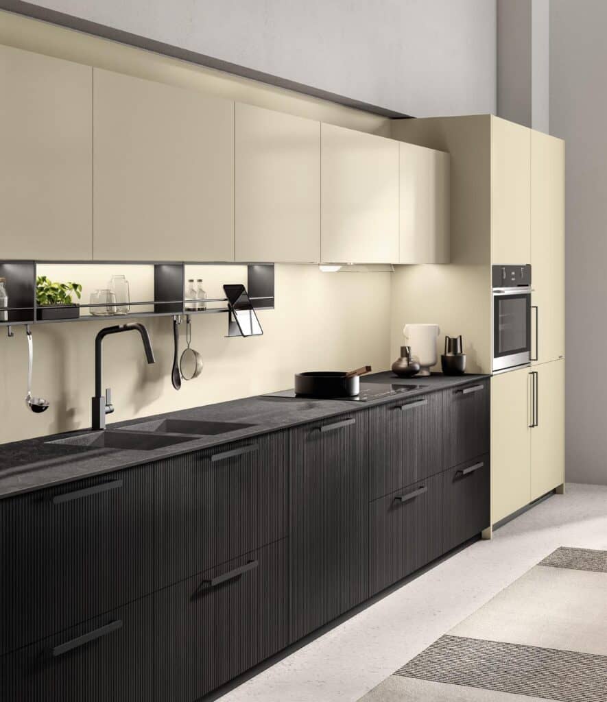 Modern kitchen with beige upper cabinets, black lower cabinets, a black faucet, and a built-in oven.