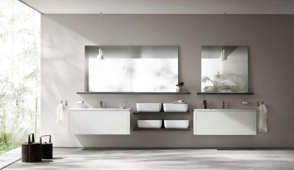 Modern bathroom with two sinks, large mirrors, and minimalistic decor.