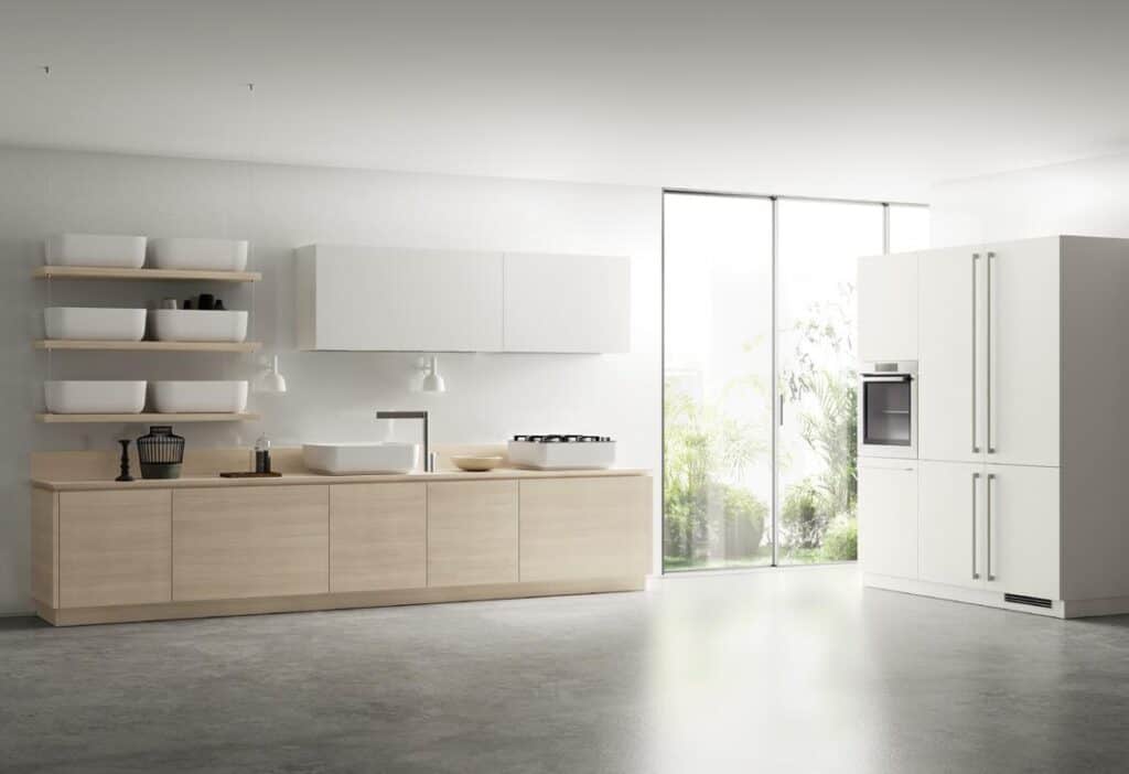 Modern kitchen with light wood cabinets, open shelving, a sink, and a stove, featuring floor-to-ceiling windows and white cabinetry.