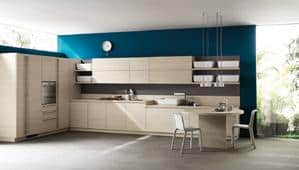 Modern kitchen with light wood cabinets, a teal accent wall, and a small dining area.