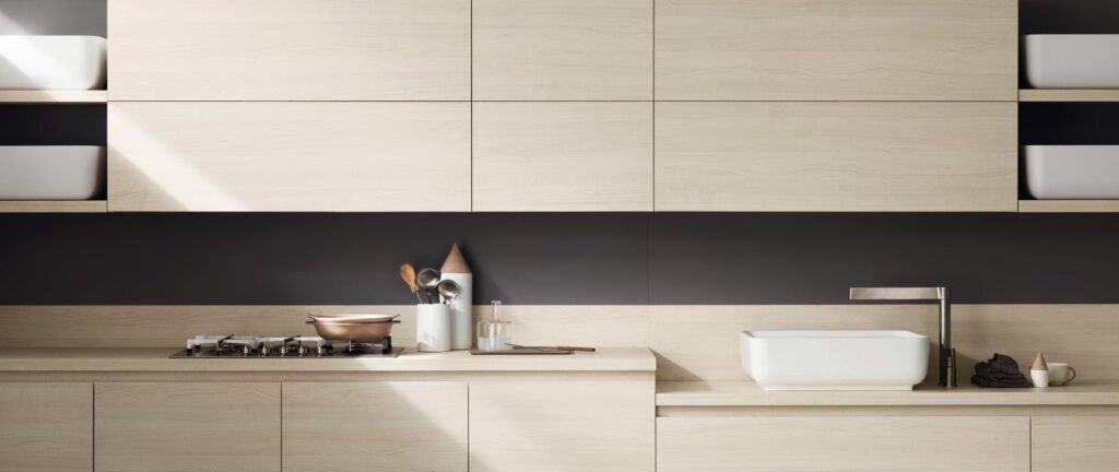 Modern kitchen with light wood cabinets, open shelving, a black backsplash, a gas stove, a sink with a square faucet, and minimalistic decor.