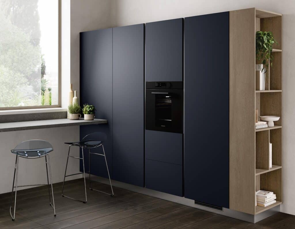 Modern kitchen with dark cabinets, built-in oven, light wood shelving, and transparent bar stools near a large window.