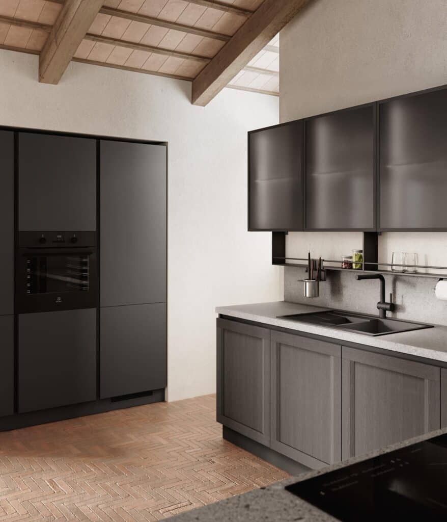 Modern kitchen with dark cabinetry, built-in black appliances, gray countertops, and a herringbone brick floor under a beamed ceiling.