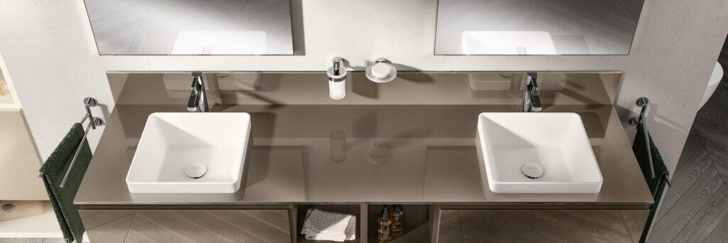 Modern bathroom with double rectangular sinks, large mirrors, and neatly arranged toiletries below the countertops.