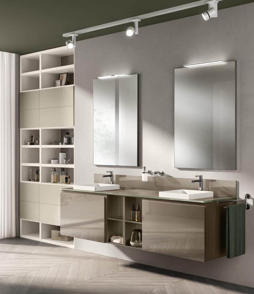 Modern bathroom with two rectangular mirrors, dual sinks on a glossy floating vanity, and open shelving units with various toiletries.