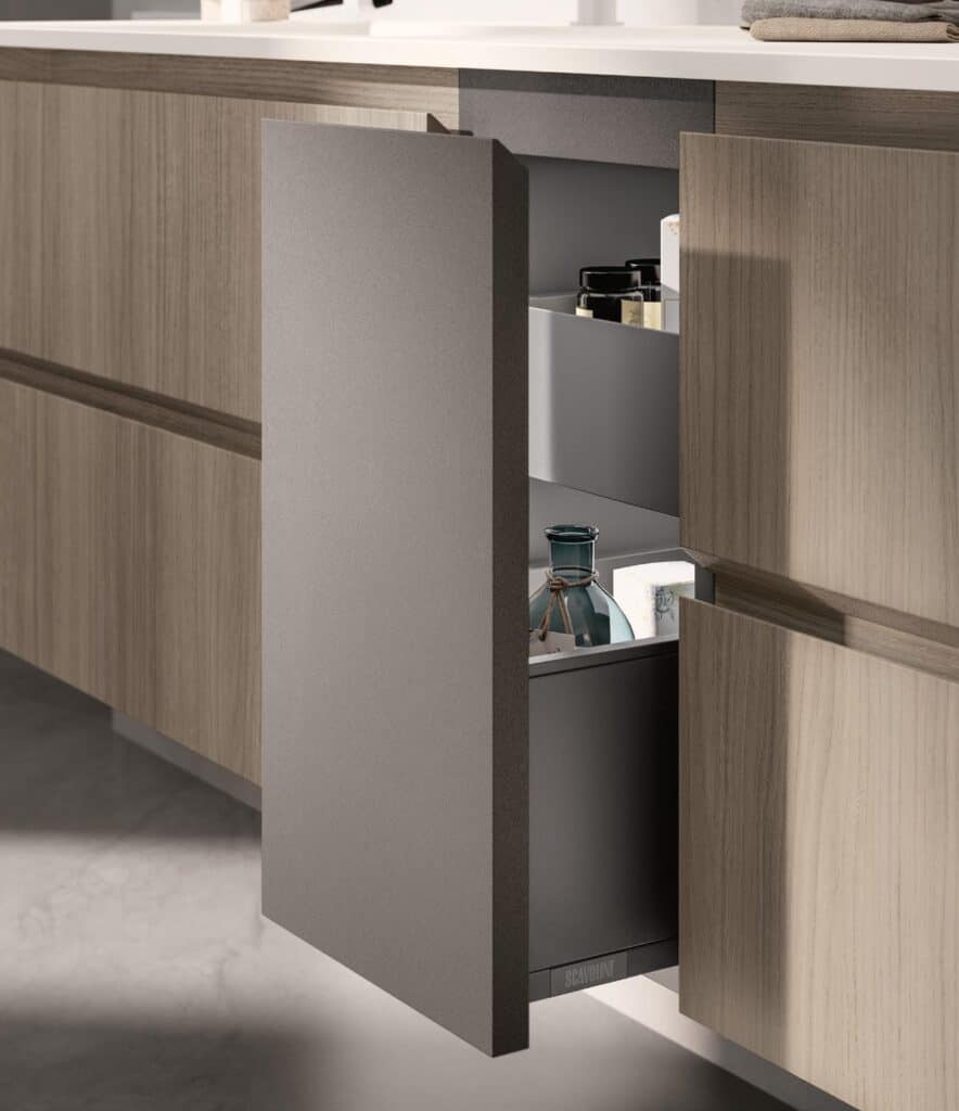 Kitchen cabinet with a partially open drawer revealing jars and bottles inside.