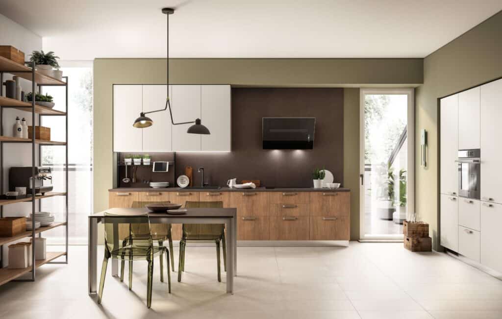 Modern kitchen with wooden cabinets, white upper cupboards, and a dark backsplash. A dining table with transparent chairs is in the center, under a pendant light. French doors lead to a patio, and open shelving displays kitchen items.