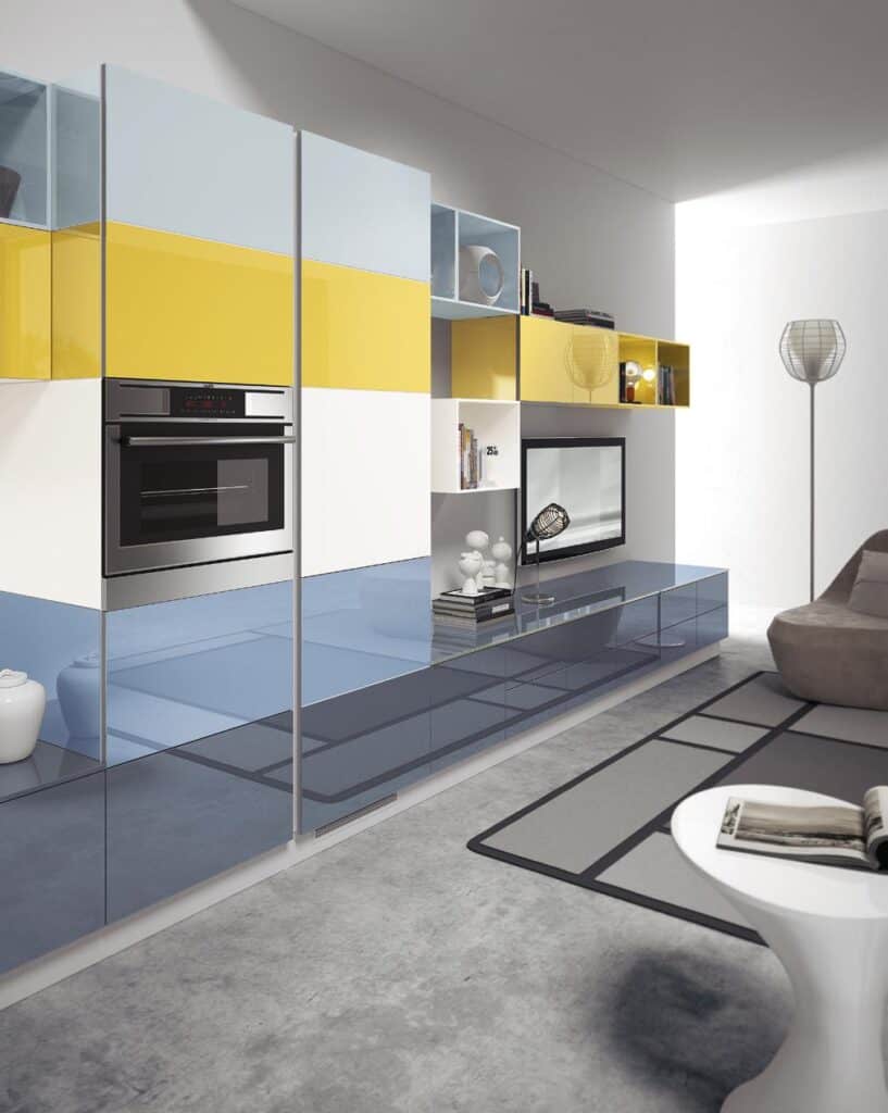 Modern living room with colorful wall-mounted cabinets, built-in oven, and sleek decor.