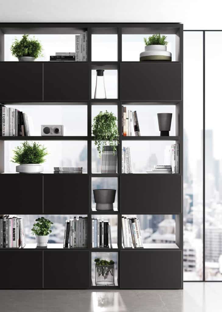 Modern shelf with books, potted plants, and decorative items against a city skyline background.