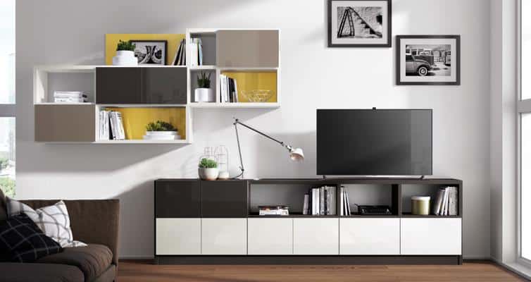 Modern living room with a wall-mounted shelving unit, a flat-screen TV on a console, and framed pictures above.