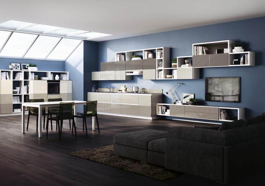 Modern open-concept kitchen and living area with blue walls, glossy cabinets, a dining table, dark wood flooring, and a skylight.