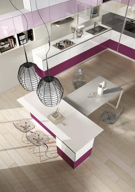 Modern kitchen with white and purple cabinets, two black pendant lights, a white island, and transparent chairs.