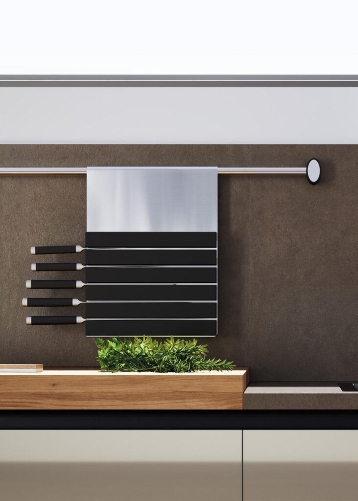 Modern kitchen with magnetic knife holder and herbs on wooden countertop.