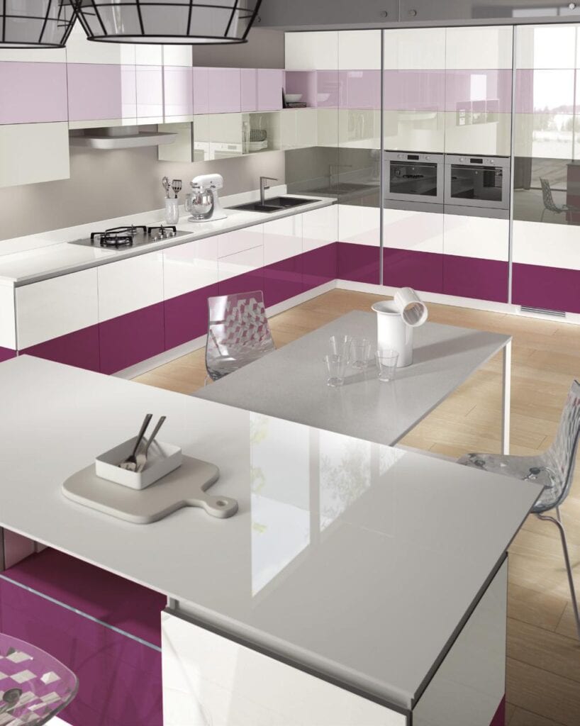 Modern kitchen with glossy white and purple cabinets, built-in ovens, a gas stove, and a kitchen island with transparent chairs.