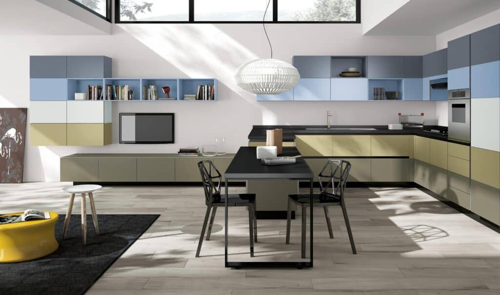 Modern kitchen and dining area with multicolored cabinets, black dining table with chairs, and a large pendant light.