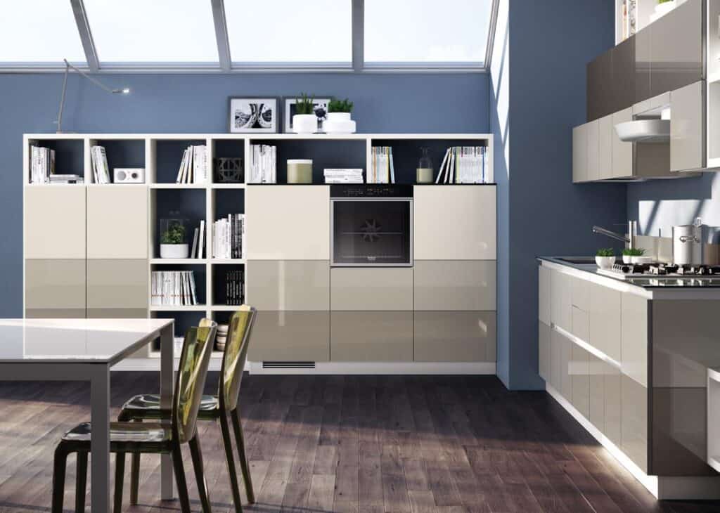 Modern kitchen interior with beige cabinets, wall shelves, and a built-in oven, under a skylight.