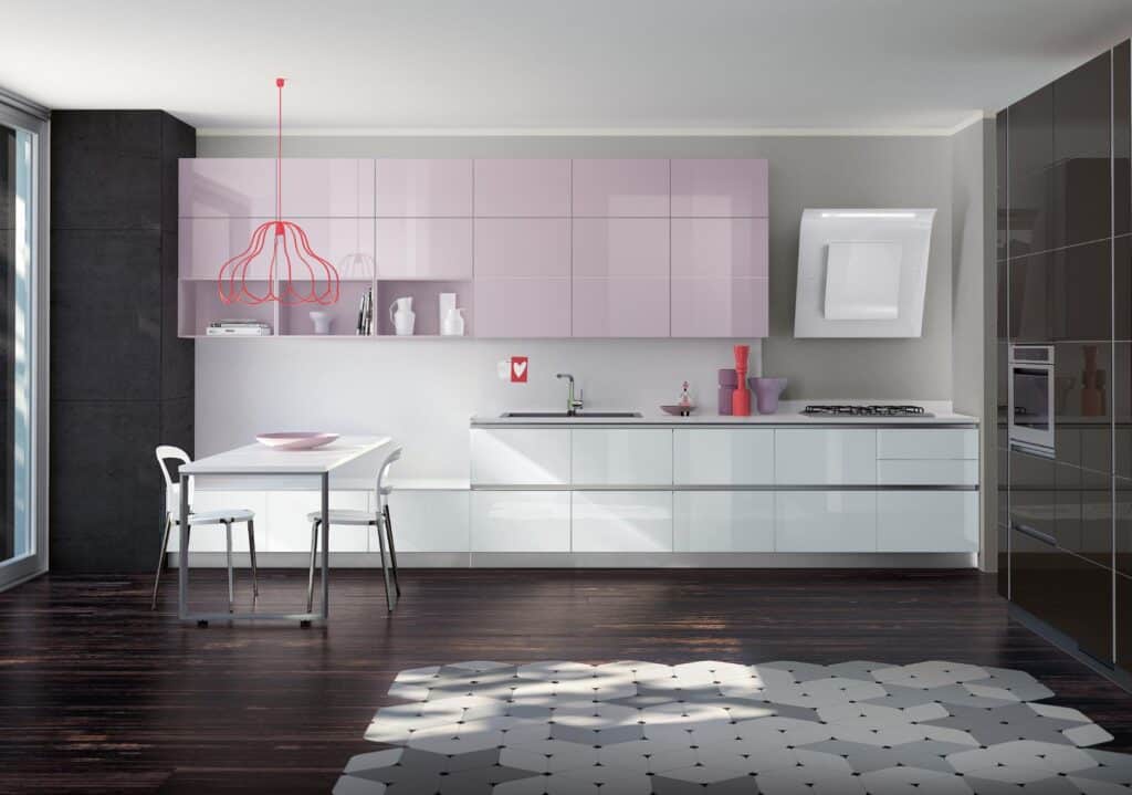 Modern kitchen with sleek cabinetry, a dining table with two chairs, a red wireframe pendant light, dark wood flooring, and a geometric rug.