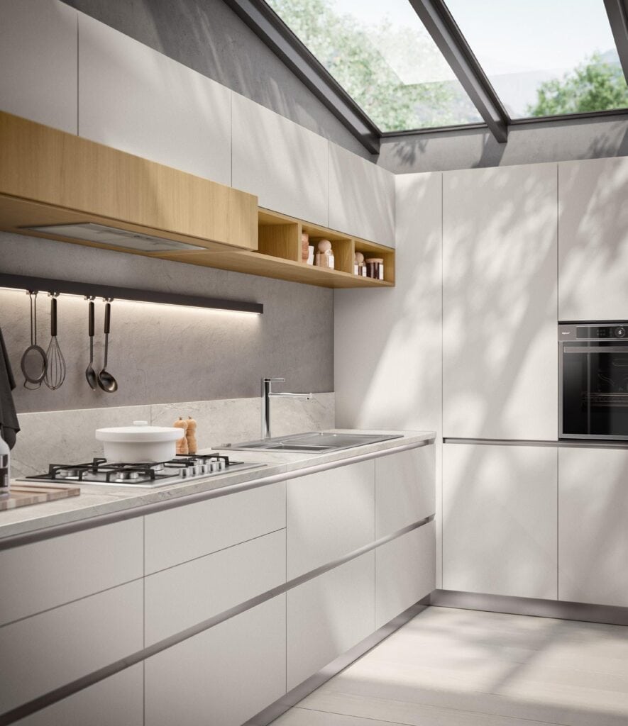 Modern kitchen with white cabinets, sleek appliances, gas stove, and overhead shelving beneath a glass ceiling.