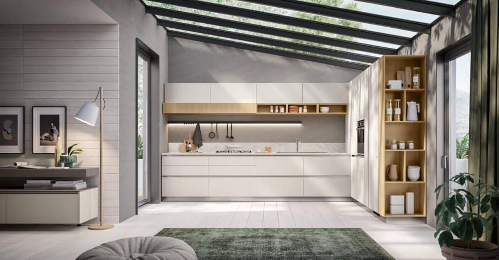 Modern kitchen with white cabinets, light wood shelving, and a glass roof.