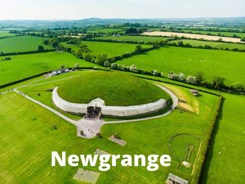 Ancient Irish Ring Fort at Newgrange surrounded by lush green fields in Ireland.
