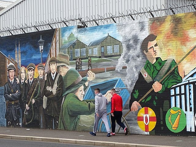 Vibrant Irish mural depicting historical and modern scenes of Irish military and cultural heritage.