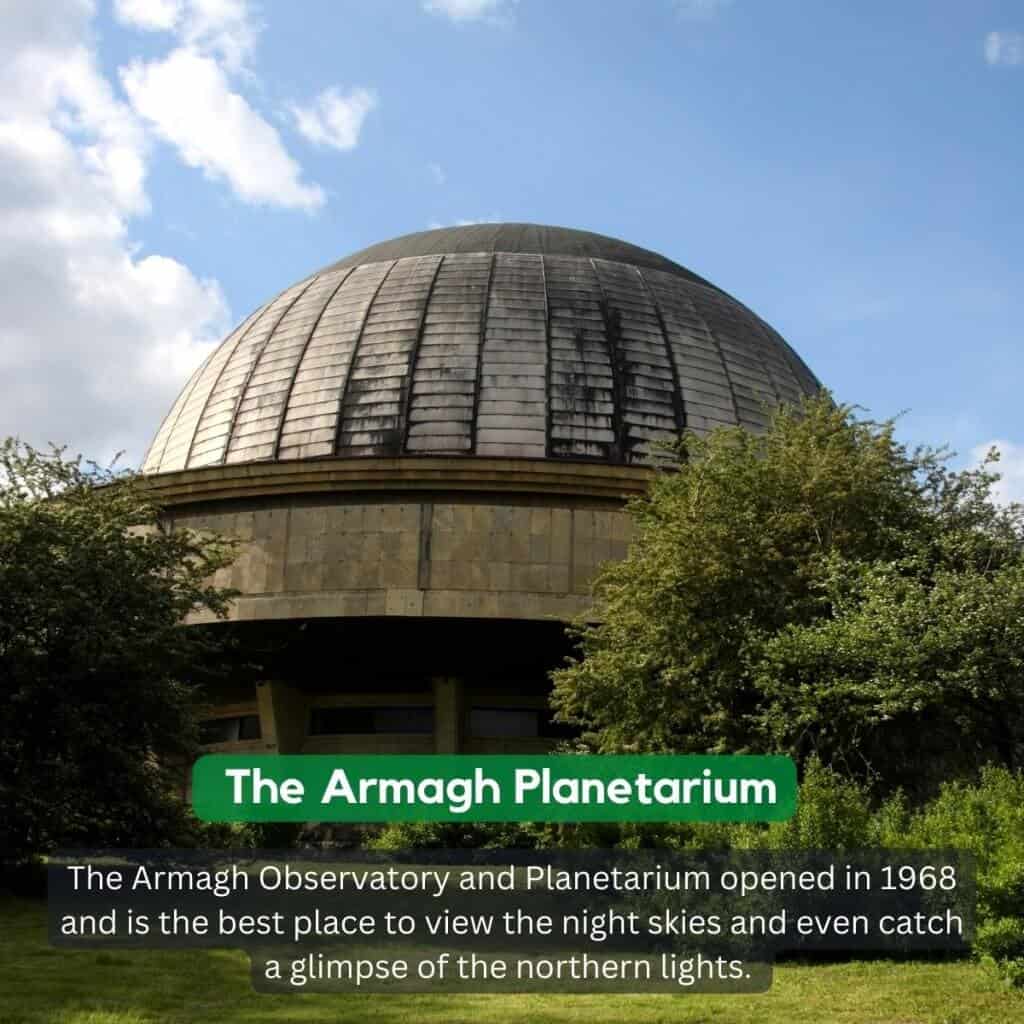 Dome of the Armagh Planetarium with trees and sky background.