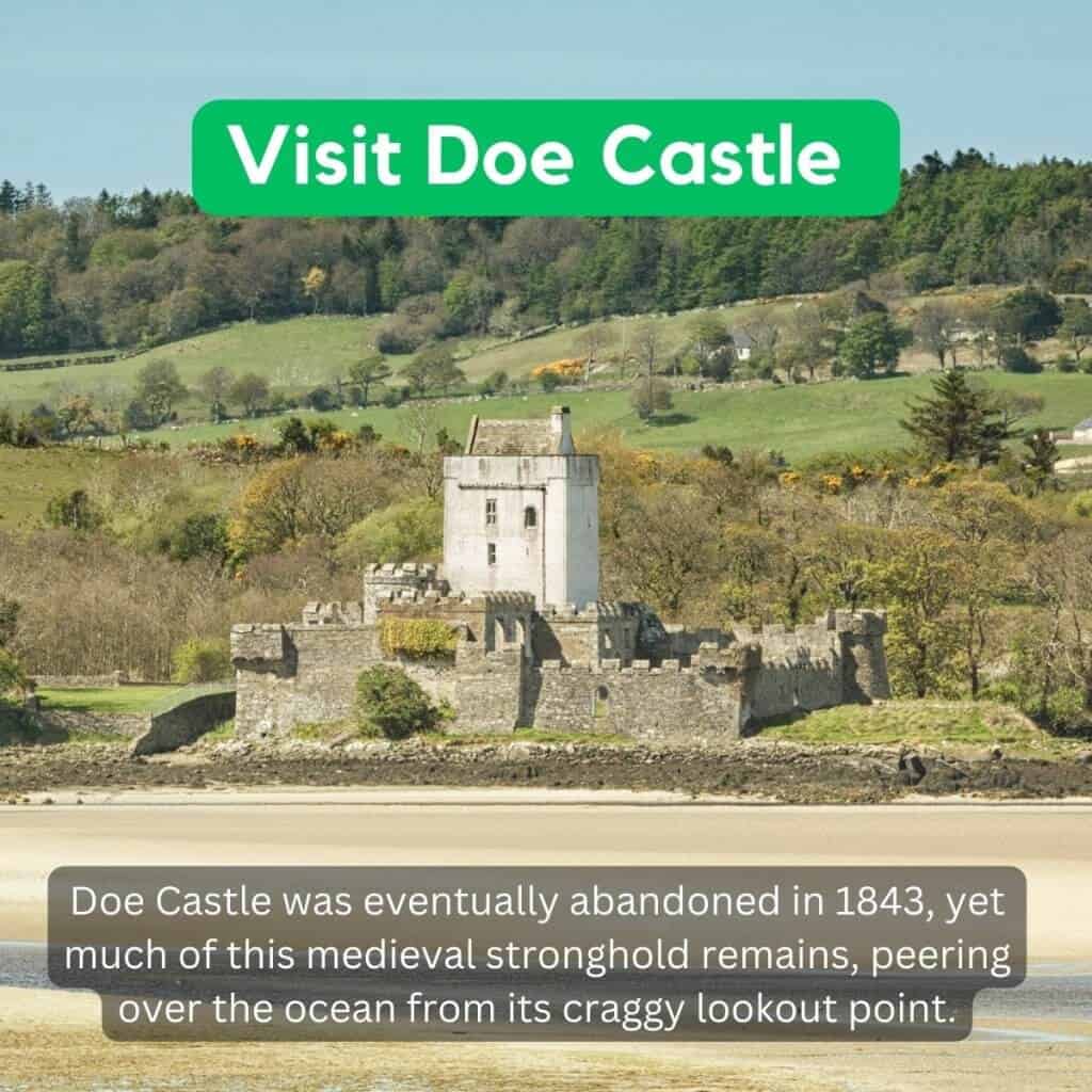 Ruined medieval castle on Irish coastline surrounded by lush green hills.