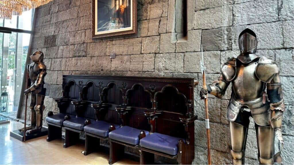 Shiny medieval suits of armor displayed inside a castle or museum in Ireland.