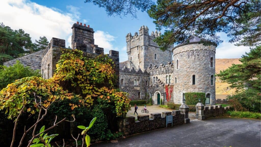Ancient Irish castle surrounded by lush greenery in a scenic rural setting.