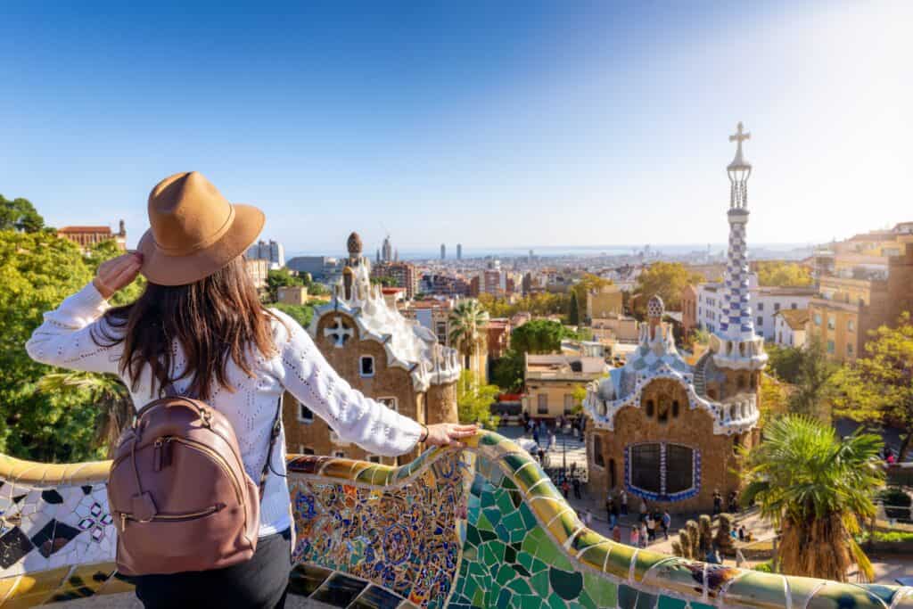 Woman with hat overlooking Park Güell in Barcelona, Spain.