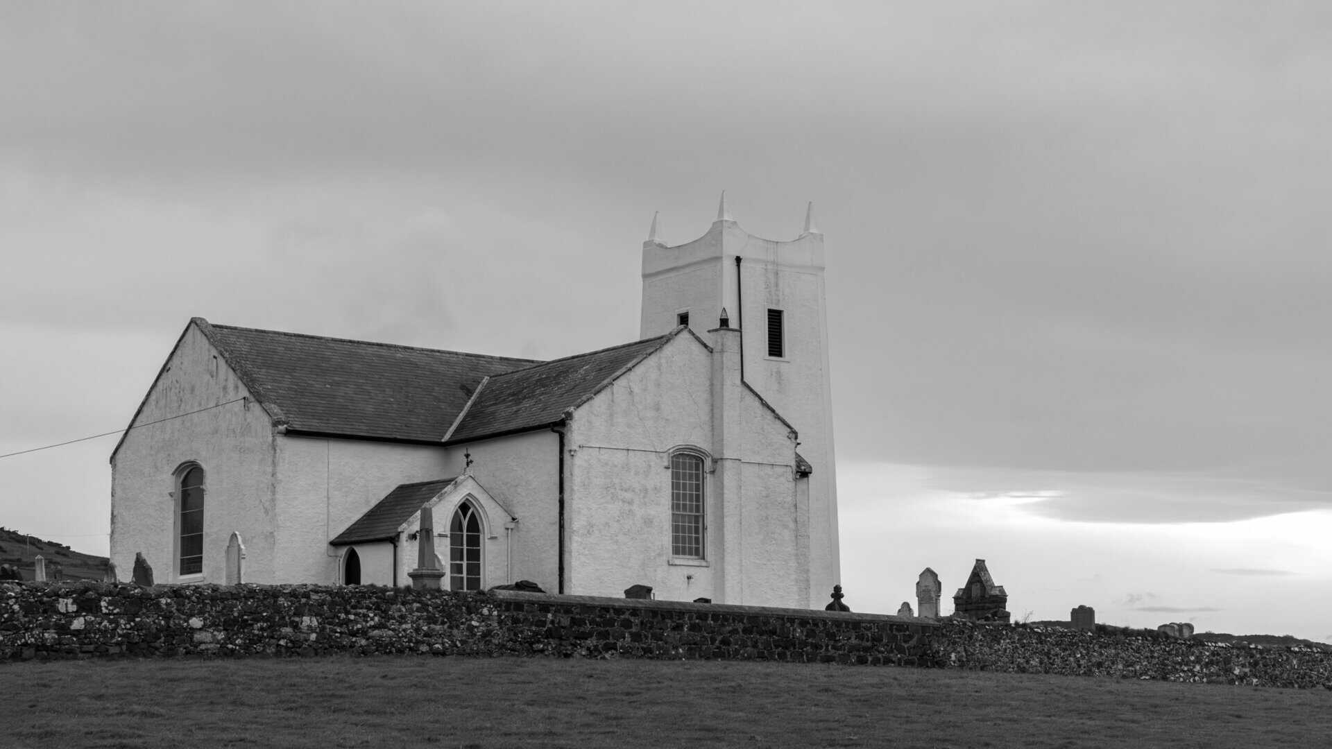 Black and white photo of a historic church in Ballintoy, Northern Ireland.