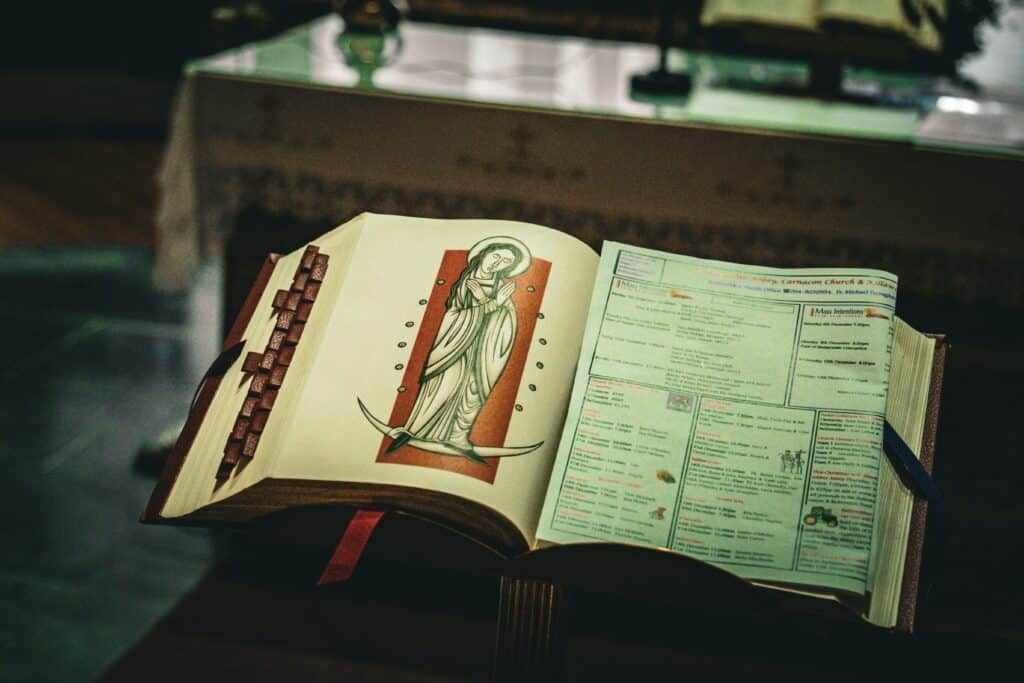 An open prayer book with religious imagery inside a church in Ireland, capturing spiritual essence.