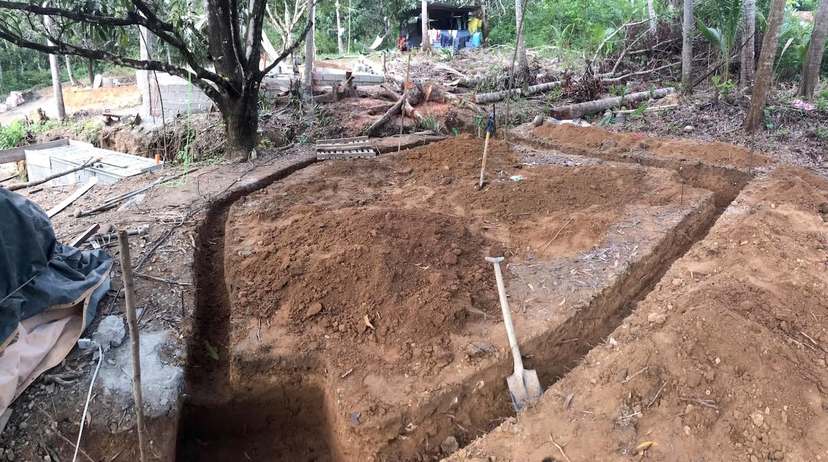 Excavated soil and construction tools at a rural site in the Philippines. Earthwork preparations underway for new building project.