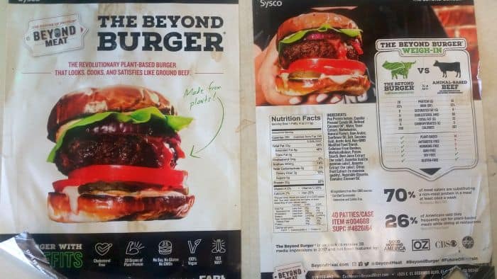 The Beyond Burger packaging invites you on a flavorful road trip. The front showcases a delicious burger with lettuce, tomato, and sauce, while the back offers nutritional facts and compares it to traditional beef burgers. Highlighting its plant origin, it's an adventure in every bite.
