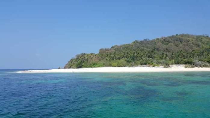 Explore the tropical paradise of Coron, where clear turquoise waters meet sandy beaches and lush green hills. Discover an array of accommodation options nestled beneath a radiant blue sky, and don't miss out on thrilling boat tours that unveil the island's hidden gems.