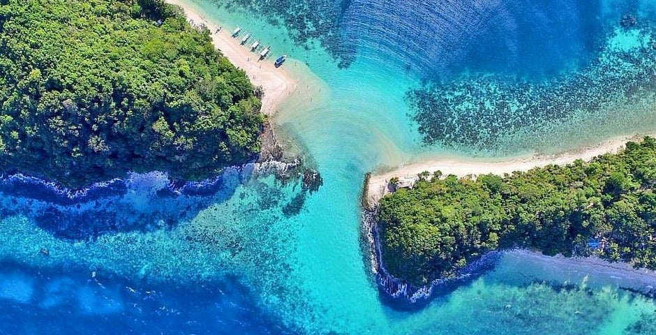 Aerial view of Port Barton with turquoise waters, lush greenery, and sandy beaches in the Philippine.