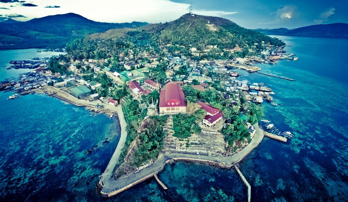 Aerial view of Culion island with historic buildings and lush greenery.
