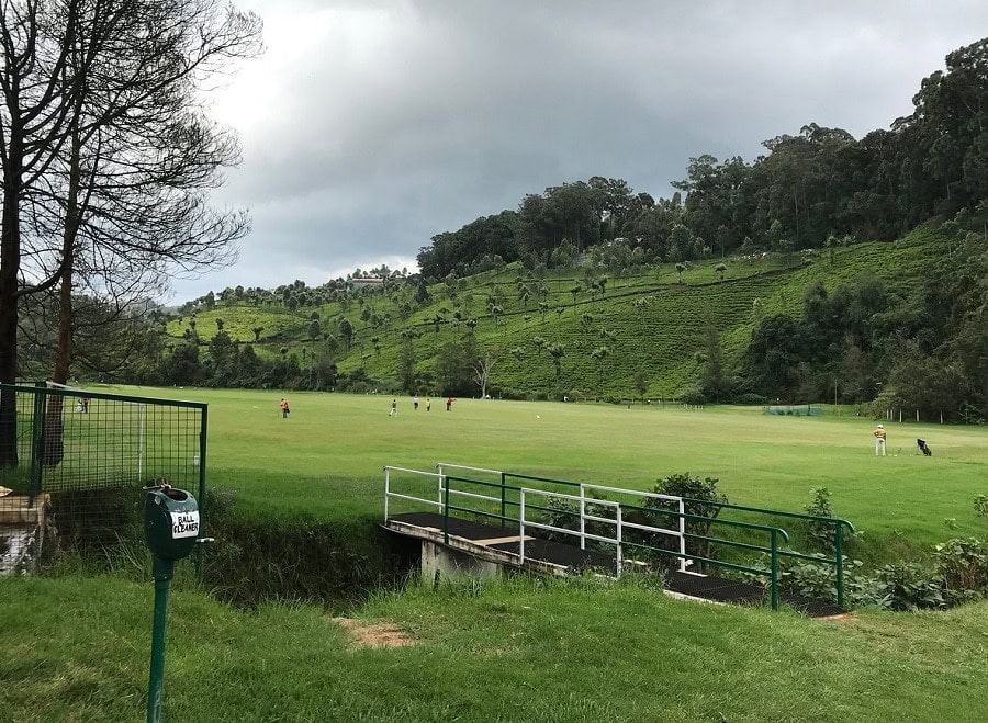 Picturesque golf course with rolling greens and scenic mountain backdrop in the Philippines.