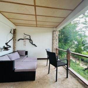 A cozy balcony with lush views of palm trees in the Philippines. Perfect for relaxing amid nature.