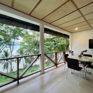 Stunning balcony overlooking lush trees and island scenery in the Philippines.