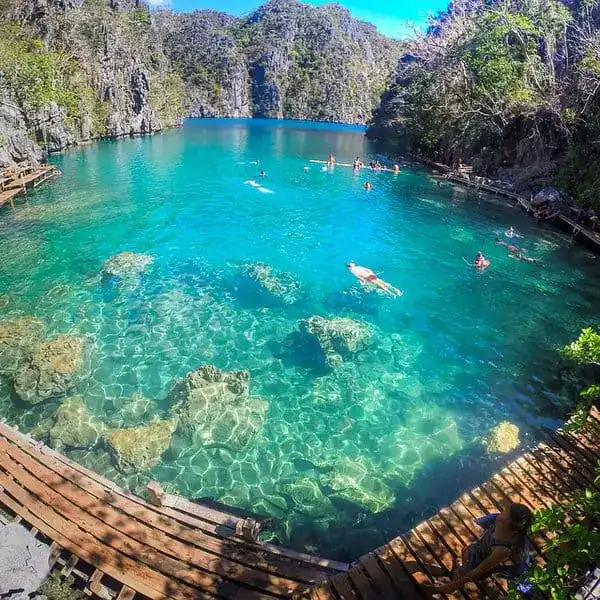 Beautiful turquoise Philippine lagoon popular for swimming and relaxation.