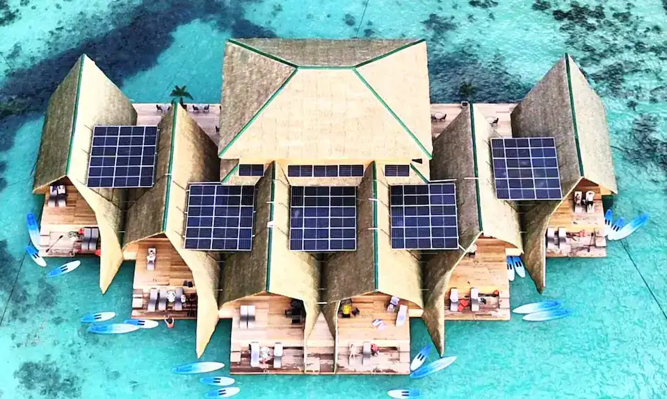 Overwater bungalow in the Philippines featuring solar panels and waterfront views.