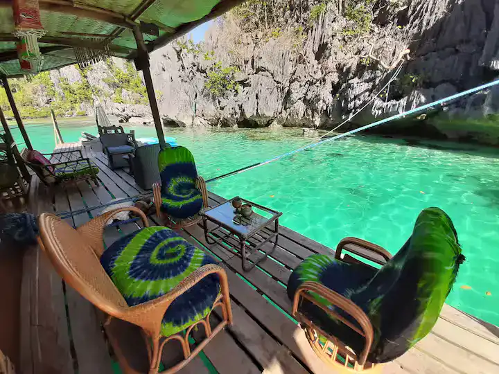 A cozy bungalow on a pier overlooking the Philippines' turquoise waters. Perfect tropical escape.