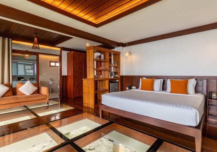 Spacious bedroom with modern decor and cozy pillows in a tropical Philippines island resort.