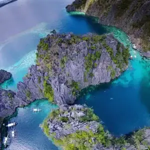 Breathtaking turquoise waters surround the Hidden Lagoon in Coron, ideal for island hopping and snorkeling adventures.