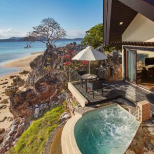 Stunning beachfront villa overlooking crystal-clear waters and sandy shores.