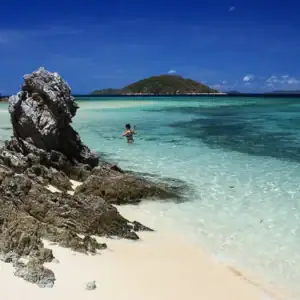 Pristine turquoise waters with rocky shoreline in the Philippines.