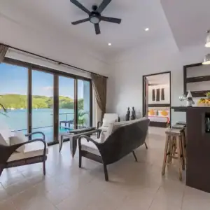 Spacious hotel living room overlooking water, perfect for relaxing vacations in the Philippines.