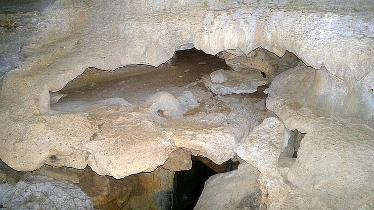 Exploring a limestone cave with unique rock formations in the Philippines.